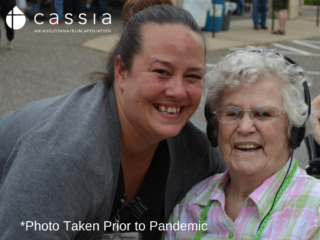 Stacy Spotts smiling, standing next to a resident of her community