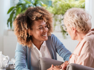 Caregiver smiling at senior