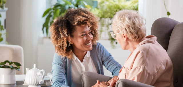 Caregiver smiling at senior